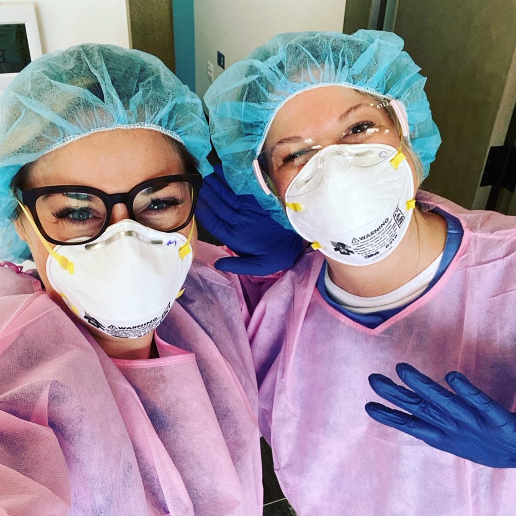 Dr. Posthuma and Carrie smile under their protective masks during COVID-19